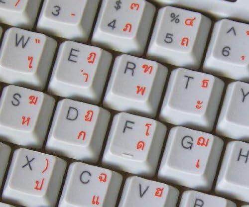 Etiquetas de teclado tailandês com letras laranja em fundo transparente